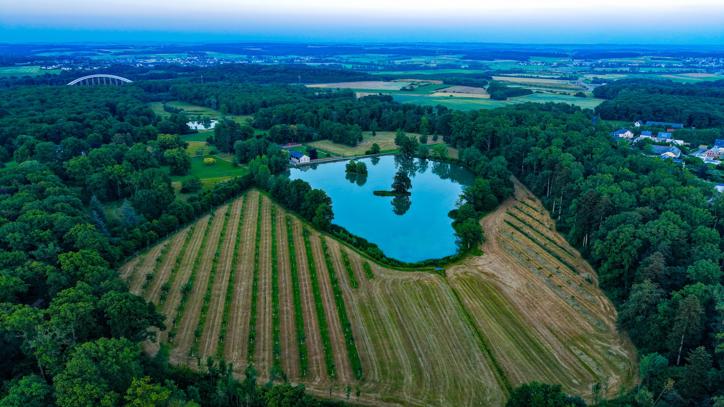 The southern edge of Luxembourg City from altitude. The Gasperich towers are visible to the north; the farmland communes begin to the south. This is the line, for now.