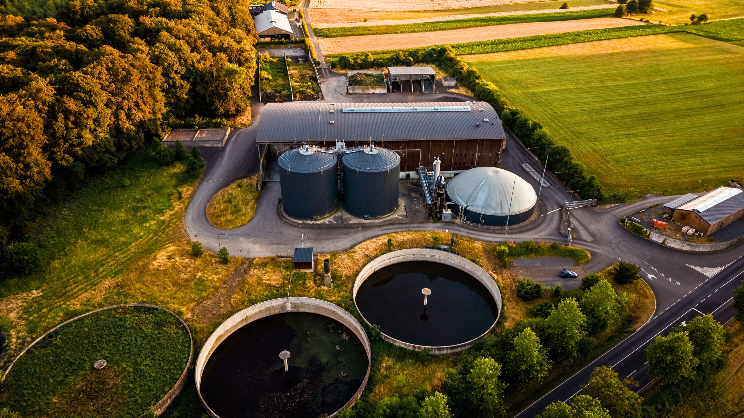 Three circular settling tanks of a biogas plant near Marienthal — industrial infrastructure abstracted to pure geometry from directly above